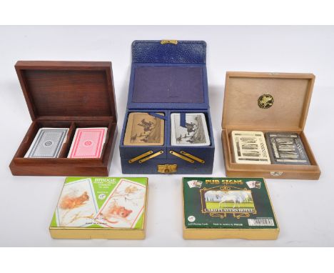 A collection of vintage 20th century card cases and playing cards to include a wooden example inlaid with brass playing card 