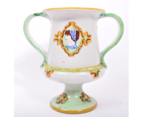 A 19th century Italian majolica two handled loving cup vase having an hand painted portrait panel. Marked to base. Measures a