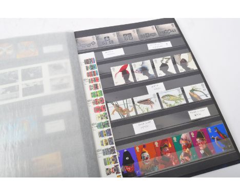A collection of 20th century unfranked post decimal British postage stamps held within a single blue leather album. Face valu