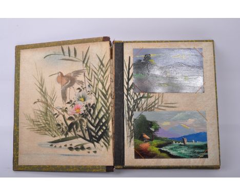 An early 20th century Japanese Oriental Shibayama lacquer postcard album. The album cover hand painted with gilt decorations 