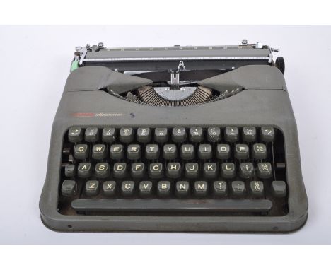 A vintage 20th century Empire 'Aristocrat' portable typewriter in grey case. Case measuring approx. 28 x 28cm.&nbsp;