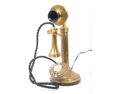 A 20th century vintage brass and Bakelite candlestick telephone with chrome metal dial. Measures 32cm tall.