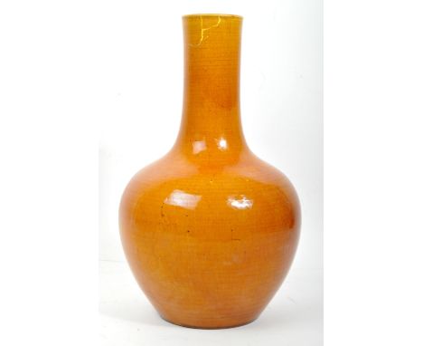 A vintage 20th century Ming Hongzhi style ceramic ochre vase of bulbous shaped with tall neck. It measures approx. 33cm tall.