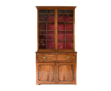 A George IV Mahogany Secretaire Bookcase, 2nd quarter 19th century, the upper section with glazed doors with fluted moulding 