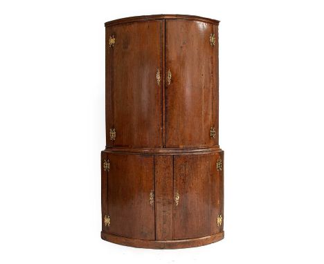 A George II Oak and Mahogany Crossbanded Free-Standing Corner Cupboard, 2nd quarter 18th century, of broad proportions, the m