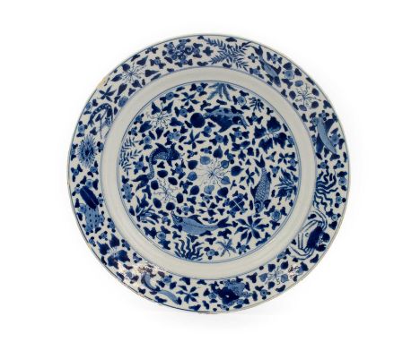 A Chinese Porcelain Dish, Xuande reign mark but Kangxi period, of circular form, painted in underglaze blue with fish amongst