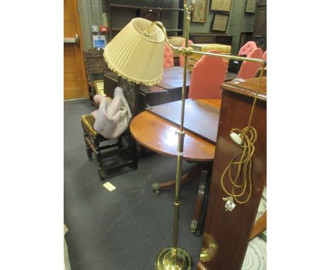 A brass adjustable reading lamp  