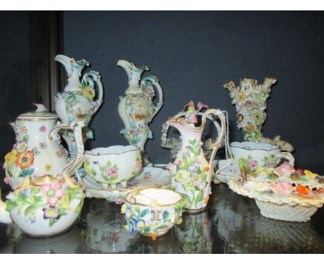 A group of continental floral encrusted porcelain to include two Meissen cups and saucers and a Meissen miniature jug and cov