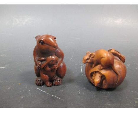 A netsuke, carved as a hare with a leverett, signed; another as two rats with an apple (2)  