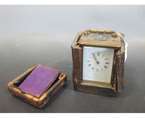 An Edwardian brass carriage clock, striking on a gong, retailer's name, J Bagshaw & Sons Paris, with travel case  