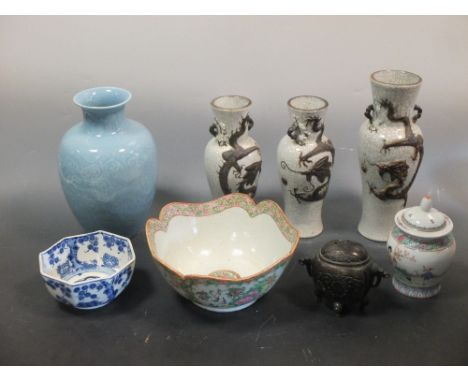 A group of Oriental items to include a Cantonese famille rose bowl, a garniture of cracked Celadon style vases and an embroid