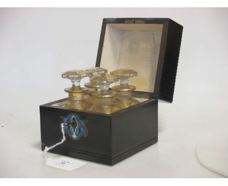 A late 19th century ebonised and inlaid decanter box fitted with four small gilt glass bottles and stoppers  