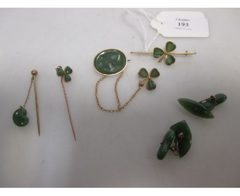 An oval green hardstone cameo brooch with safety chain and clover leaf pin, two other clover leaf pins, a pair of green hards