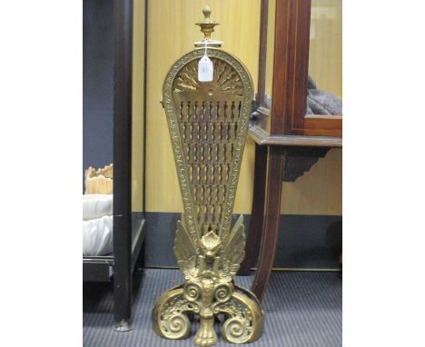 An Edwardian peacock brass fire screen  