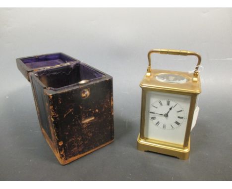 A brass cased carriage clock with gong strike, by Henri Jacot with leather travelling case 