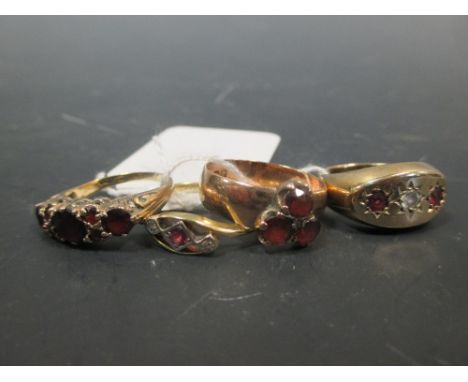 An 18ct and platinum ruby and diamond ring (2.2g) a 9ct three stone ruby and diamond ring, a 9ct three stone garnet ring and 