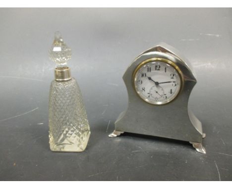 A silver mounted dressing table clock and a scent bottle  