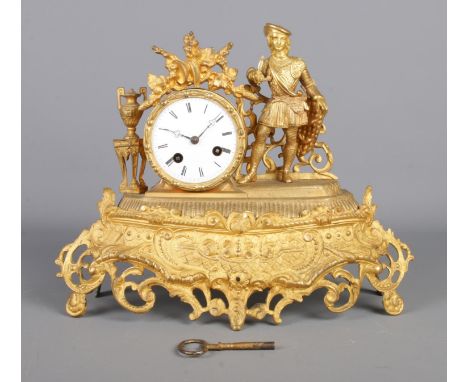 A Nineteenth Century French gilt metal mantel clock, on decorative scrolled base. The white enamel dial bearing Roman Numeral