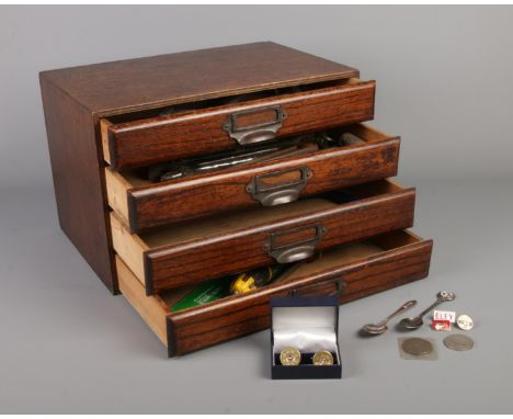An oak bank of four drawers with contents, together with a quantity of shooting collectables, including including three Eley 