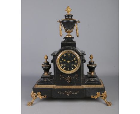 A Nineteenth Century French black slate mantel clock, with gilt detailing. Featuring Roman Numeral markers to the dial, parti