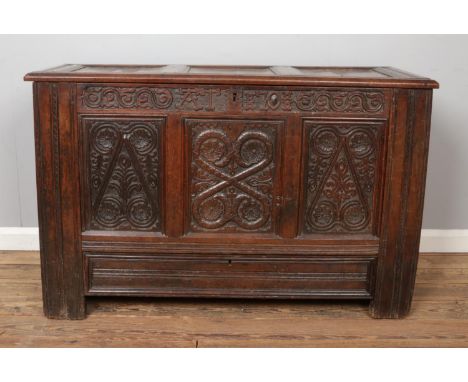 A period carved and panelled oak coffer, with single drawer. Height 78cm, Width 123cm, Depth 54cm.  Signs of woodworm.