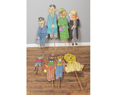A collection of hand drawn two dimensional characters possibly former theatre/stage props.