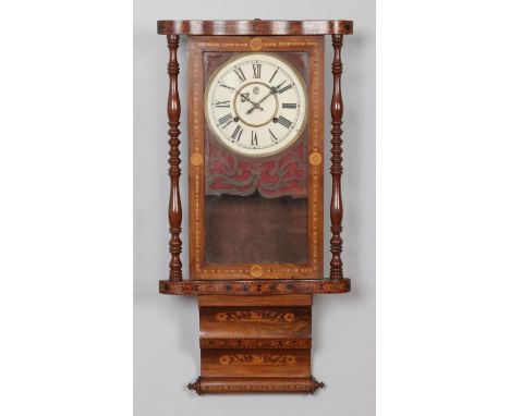 A Nineteenth Century Waterbury Clock Company Anglo-American marquetry wall clock, with turned column supports. Chiming on a c