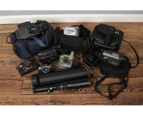 A box of cameras and video recorders. Includes Cinerex Super 8, Halina 3000, Praktica MTL5B, Sanyo PS12, The Button polaroid,