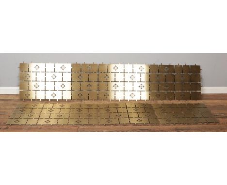 A pair of polished brass-effect metal panels with pierced geometric patterns of the Calatrava Cross (Patek Philippe), each me
