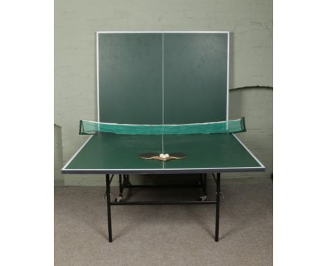 A Butterfly folding table tennis table with accessories.
