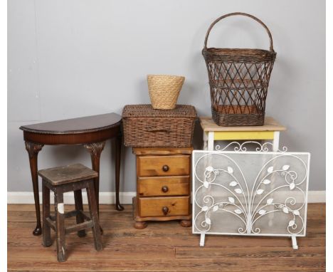 Mixed furniture with assorted wicker baskets, including stool, demi-lune console table, bedside table and white metal fire sc