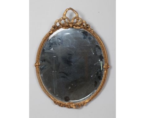 A gilt framed circular bevel edged wall mirror with bow detail to frame. Approx. diameter 38cm.