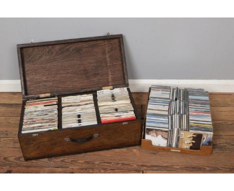 A large box of CD's with a large box of singles including Tina Turner, Savage Garden, Michael Jackson, Madonna, R.E.M, Kings 