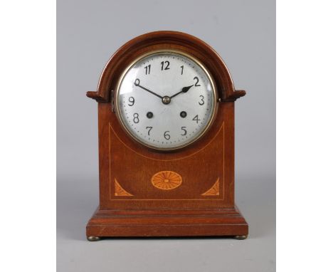 A mahogany cased mantel clock, by the Salisbury Clock Company. Featuring fan patera inlay to the body and having silvered dia