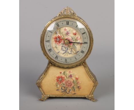 A vintage musical dressing table clock, featuring embroidered panel and decoration with Swiss Thorens movement playing "Sprin