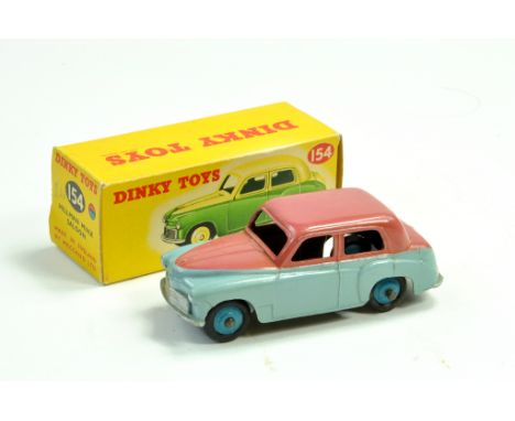 Dinky No. 154 Hillman Minx Saloon in two-tone light blue and cerise, silver trim with mid-blue ridged hubs. Slightly faded bu