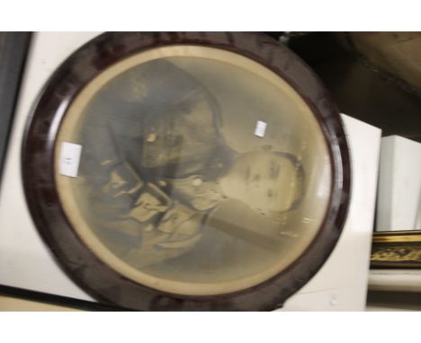 AN OVAL FRAMED PRINT OF A SOLDIER