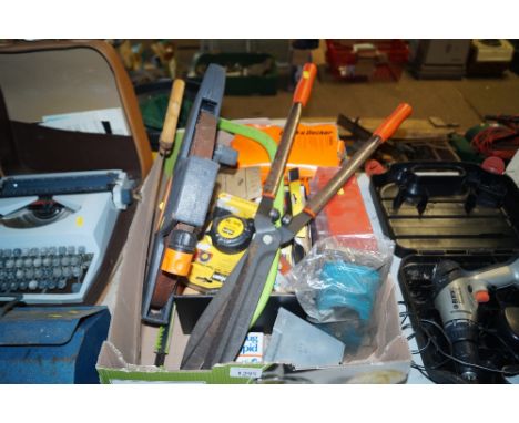 A box containing various tools to include shears; tape measure etc