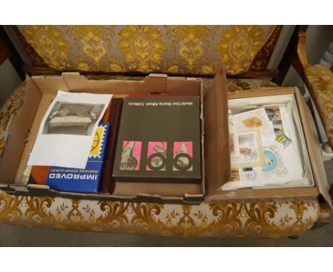 A box containing First Day covers and albums of stamps