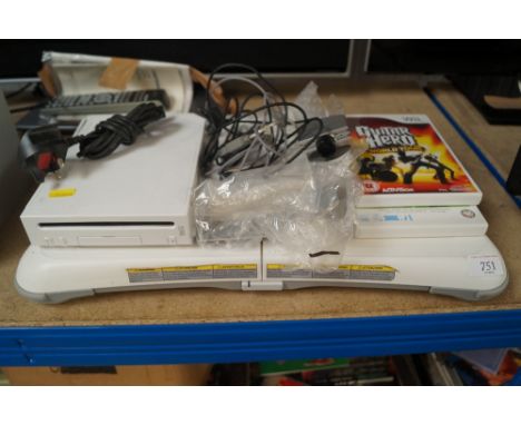A Nintendo Wii console with fit board and other accessories