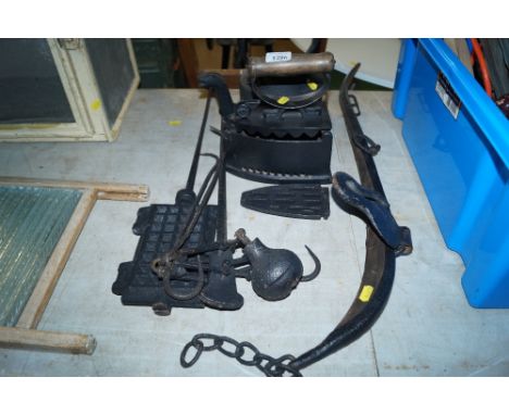 A waffle maker; a meat scale; iron trivet; kettle etc