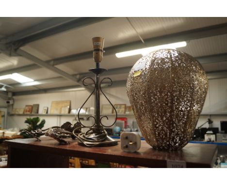 A pair of brass candle sconces and a decorative table lamp and shade
