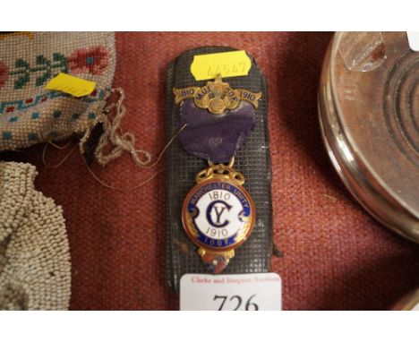 A spectacle case and a Spencer of London enamel decorated Manchester Unity Medal with presentation inscription "Verso"