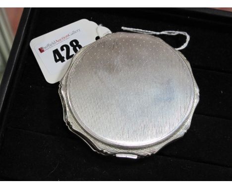 KIGU; A Hallmarked Silver Powder Compact, KLd, London 1967, of shaped circular form, allover engine turned, 7.5cm wide.