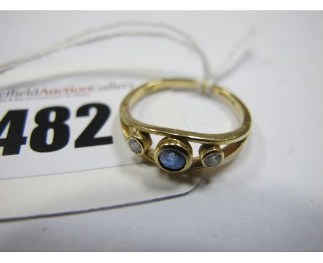 An 18ct Gold Sapphire and Diamond Three Stone Ring, graduated collet rubover set, between bifurcated shoulders (finger size M