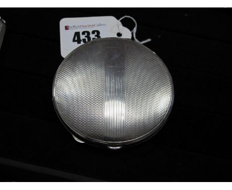 A Hallmarked Silver Powder Compact, D&amp;F, Birmingham 1938, of circular form, allover engine turned, 7.3cm diameter.