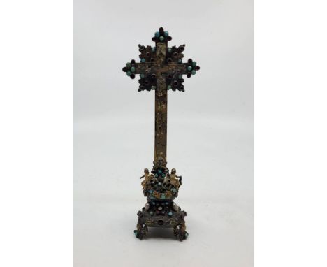 A 19th century Austro-Hungarian unmarked silver gilt, polychrome enamel and gem stone set cross,&nbsp;the cross foliate engra