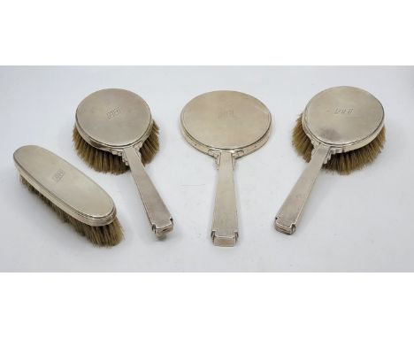 An Art Deco style engine turned silver dressing table set, by William Comyns &amp; Sons Ltd, London 1947, comprising hand mir
