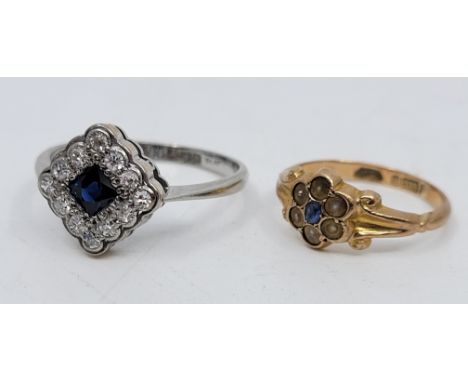 An 18ct. gold, platinum, sapphire and diamond cluster ring, the lozenge mount set French cut sapphire to centre bordered by t