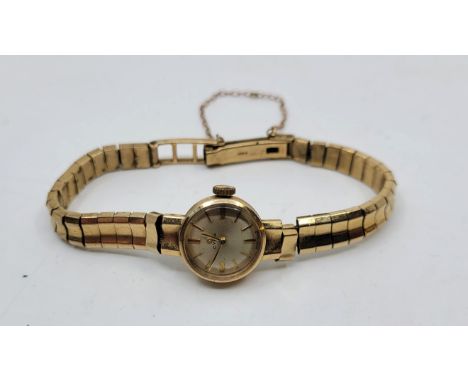 A Cyma 9ct. gold ladies' bracelet watch, manual movement, having signed silvered circular dial with gold baton hour markers, 